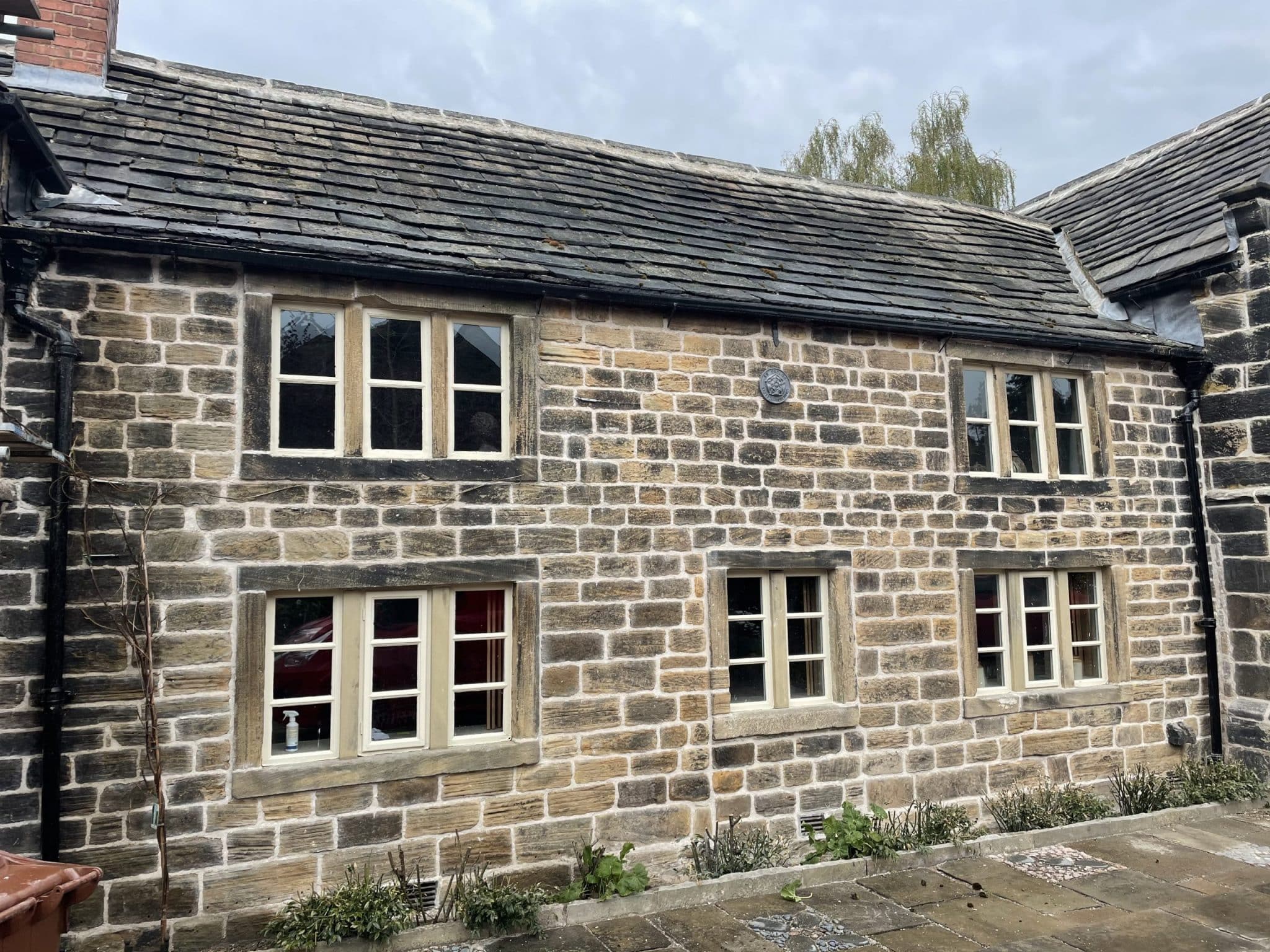 Heritage building preservation. Masonry repairs, hot lime mortar pointing at The old cottage Chapelthorpe, Wakefield, West Yorkshire