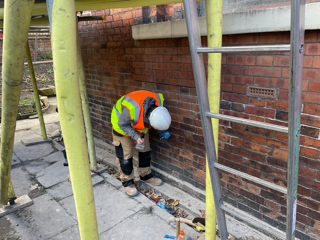 Heritage skills training in Wakefield.A Wakefield College student chiseling mortar at Westgate Unitarian Chapel in Wakefield