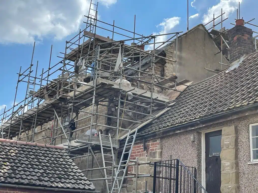 Collapsed gable caused by cement-based render