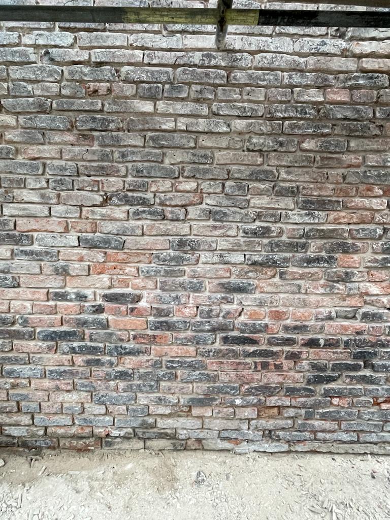 Brickwork after the cement has been removed and the  mortar joints raked clean. Fulford, York