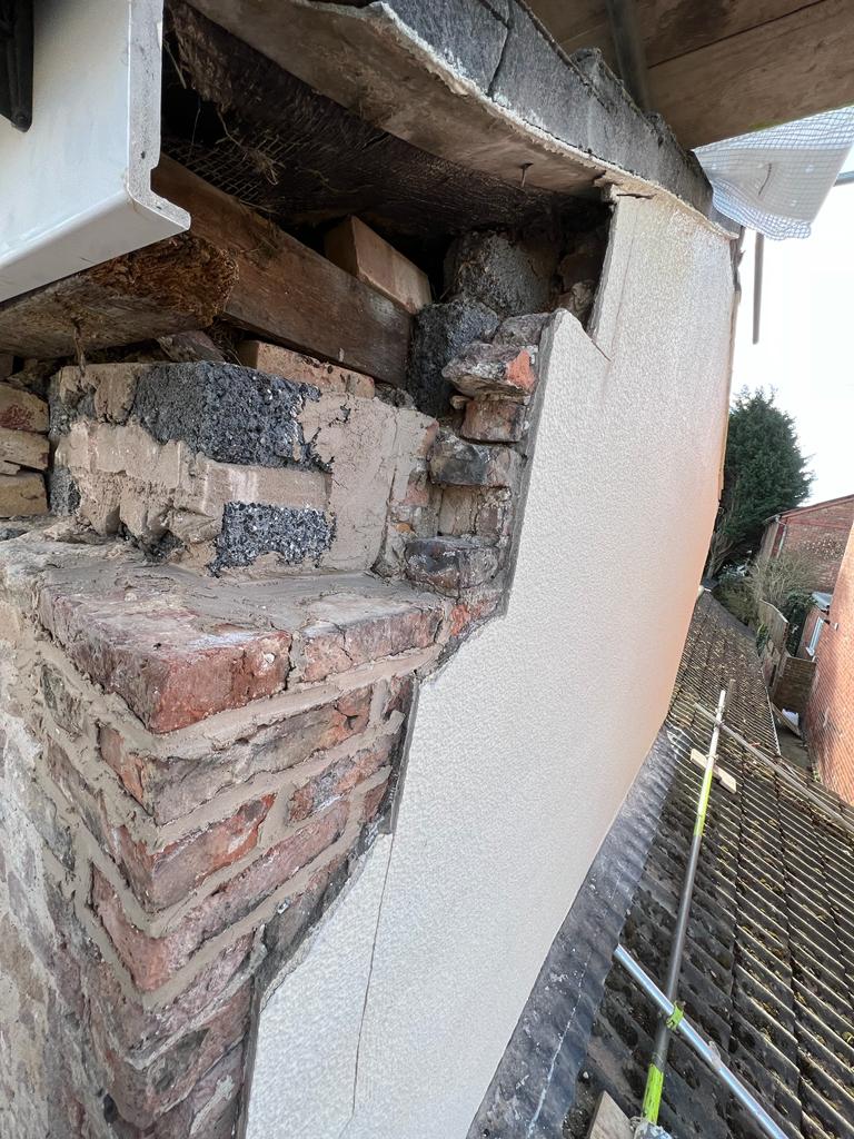 Rebuilding a brick gable after removing the cement based render from a 300 year old house in Winterton, North,East, Lincolnshire